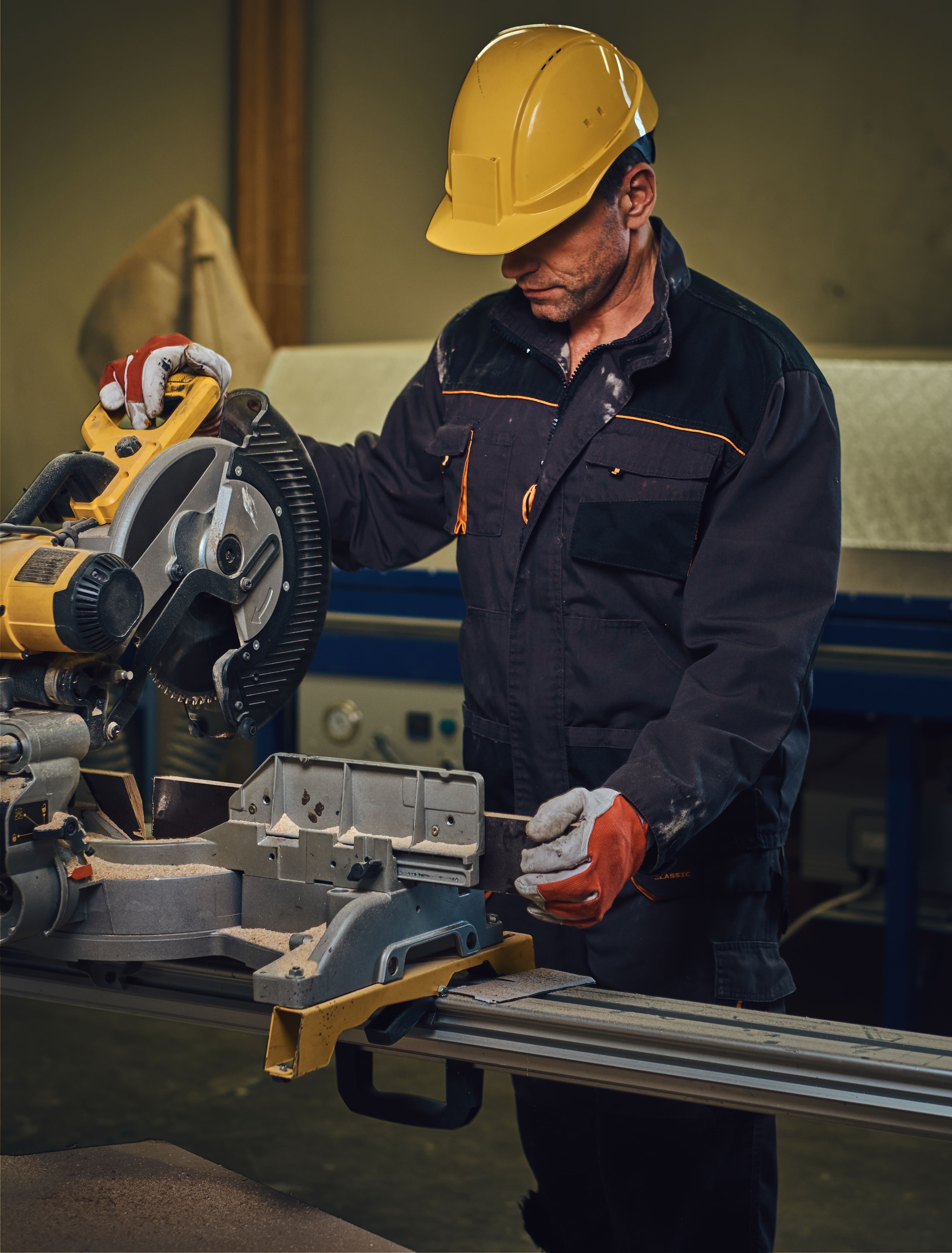 carpenter-male-dressed-safety-yellow-cap-works-with-chain-saw-garage (1)